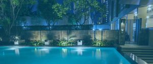 Outdoor lighting inside pool, and outside lighting on building